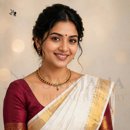 Elegant woman wearing traditional gold-toned Kemp necklace with drop earrings, maroon blouse and cream sari.