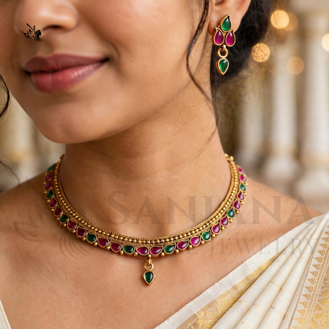 Traditional gold-toned Kemp necklace with emerald and magenta stones and matching drop earrings.
