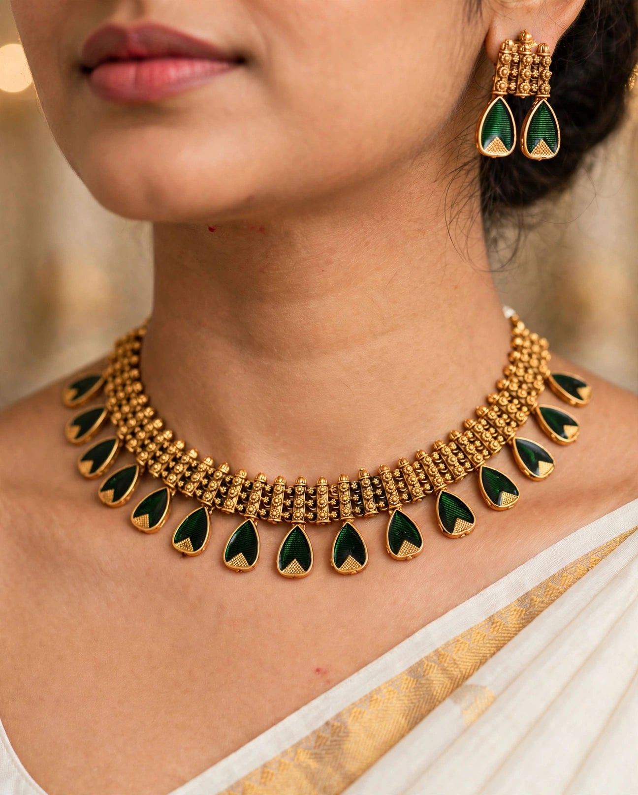 Model wearing emerald green palakka temple necklace and earrings closeup